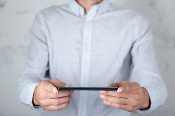 man hand smart phone on abstract background