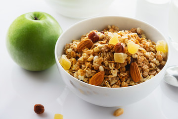 Health food. Muesli with milk and the baked apple. High key. Close up. Selective focus.