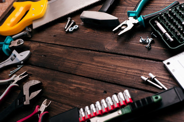 Hand tools on wooden background