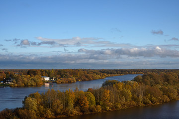 Obraz premium River with autumn forest on the banks. View from above. Volkhov River. Veliky Novgorod. North-West of Russia