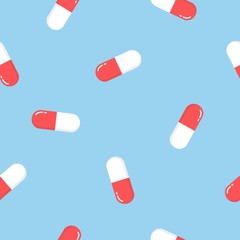Seamless pattern texture of red oval white and red medical pharmaceutical pills capsules with medicine, drugs, vitamins on a blue background.