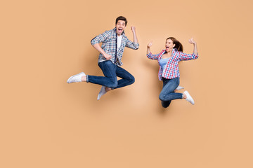 Full length photo of two people crazy lady guy jumping high raising thumbs up celebrating...