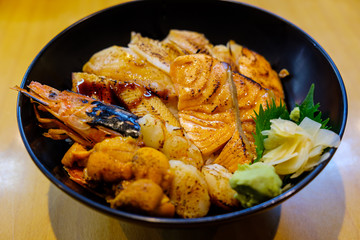 Assorted sea food served over sushi rice