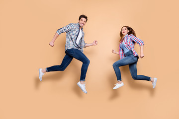 Full size profile photo of two people crazy lady guy jumping high opposite rushing men's women's stores shopping wear casual clothes isolated beige background