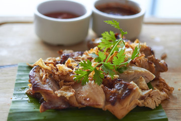 Chicken steak with dip on banana leaf in thai style