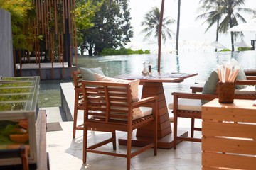 dining table on swimming pool near the beach