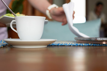hot coffee cup with waiter background