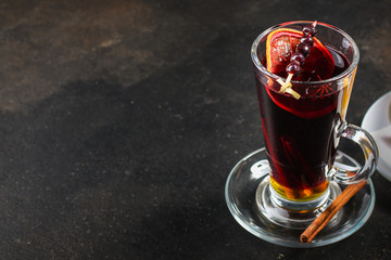 mulled wine on a wooden table. Traditional hot drink at Christmas (red wine with spices, New Year's Eve, Noel holiday festive) x-mas flat lay. food background. copy space. Top viev