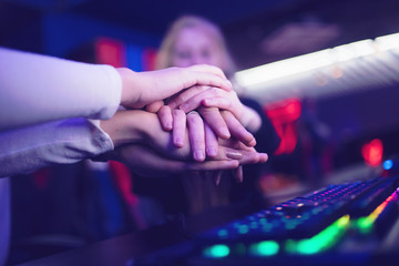 Hand of team man and girl professional gamer playing tournaments online games computer with headphones. Unity concept © Parilov