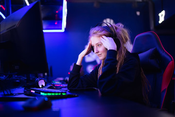 Streamer beautiful girl regrets losing professional gamer loser playing online games computer, neon color