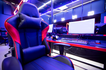 Professional gamers cafe room with powerful personal computer game chair blue color. Concept cyber...