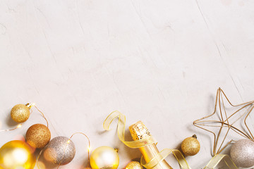Christmas festive background with golden christmas balls, confetti and champaign bottle