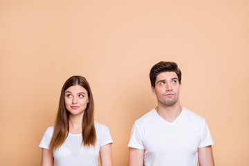 Portrait of his he her she nice attractive lovely curious bewildered couple wearing white t-shirt thinking creating solution learning isolated over beige pastel color background