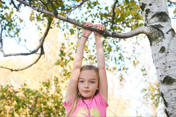 Child brave cute girl climbing on tree