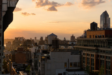 Chelsea rooftops in summer sunset light with high-rises and water towers. Manhattan, New York City, NY, USA