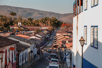 Pirenopolis, Goias, Brazil, October 17, 2019: Slopes and heavily wooded cobblestone streets with many cars in the historic center of Pirenopolis, with bars, restaurants, craft shops and entertainment.