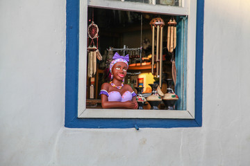 Namoradeira is a woman looking at street waiting in the window a boyfriend arrived, Brazilian handicraft made with adobe and a colonial traditional sculpture. Piren&oacute;polis, Goi&aacute;s, Brazil.