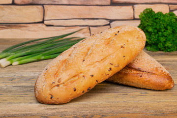 Two loaf of fresh bread with green onion and parsley