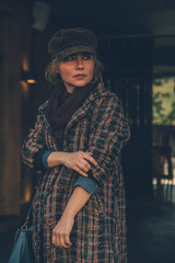 Elder adult caucasian woman on a walk in european street. Autumn retro outfit. Vintage styled and...