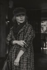 Elder adult caucasian woman on a walk in european street. Autumn retro outfit. Vintage styled and...