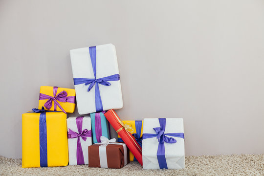 multi-colored gifts for the holiday on a gray Christmas background