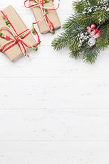Christmas card with gift boxes and fir tree branch