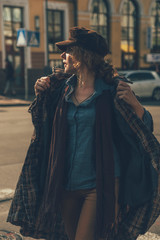 Elder adult caucasian woman on a walk in european street. Autumn retro outfit. Vintage styled and...