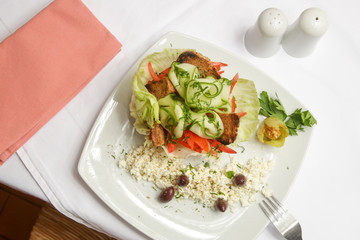 Greek salad served in a cabbage leaf