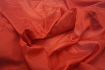 Red silk background with ripples.
