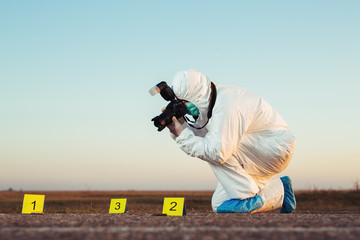 Criminological expert collecting evidence at the crime scene.