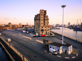 View of a quay of the port of Livorno at sunset. Old abandoned building. Industrial archeology.