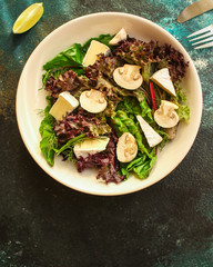 healthy salad mushrooms, cheese and green leaves (snack dish, vegetables, arugula, lettuce, spinach and more) menu concept. food background. copy space. Top view