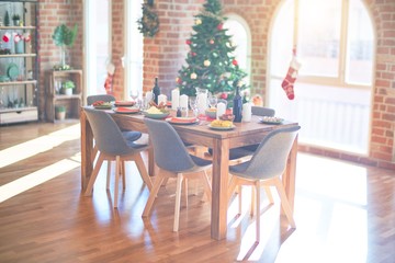 Nice home with tree, ornamets and table with food prepared to celebrate Christmas.