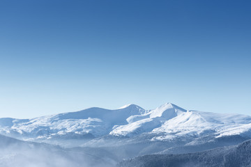 Fototapeta na wymiar Snow capped mountain peaks