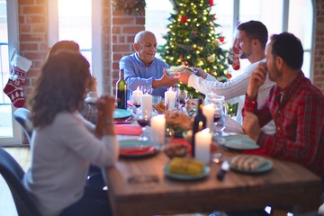 Beautiful family smiling happy and confident. Eating roasted turkey celebrating Christmas at home