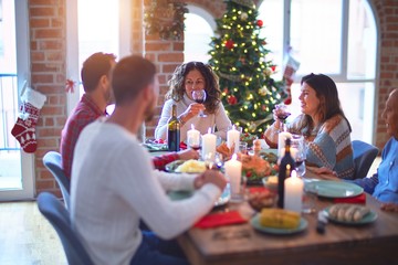 Beautiful family smiling happy and confident. Eating roasted turkey celebrating Christmas at home