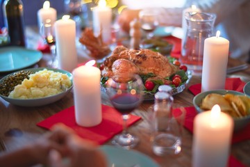 Beautiful family smiling happy and confident. Eating roasted turkey celebrating Thanksgiving Day at home