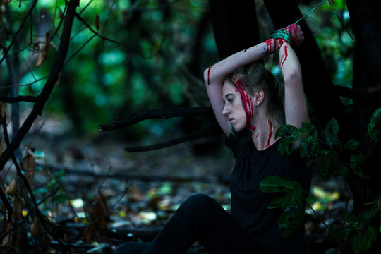 A young 20 something girl who has been kidnapped and tied up in the woods and left there alone