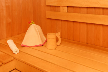 Fototapeta na wymiar Wooden empty sauna room interior as background. towel and hat for the sauna