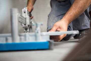 A construction worker uses a ceramic cutting machine
