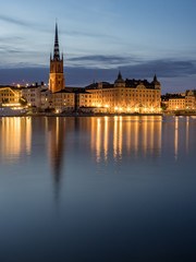 Fototapeta na wymiar Beautiful old buildings reflect in the water in Stockholm, Sweden.