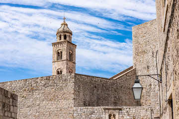 Fototapeta na wymiar Old city walls in historic Dubrovnik city, Dalmatia, Croatia, blue Adriatic Sea and blue summer sky, popular touristic destination