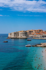 Fototapeta na wymiar Old city walls in historic Dubrovnik city, Dalmatia, Croatia, emerald Adriatic Sea and blue summer sky, popular touristic destination