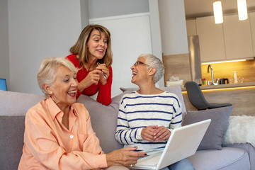 Senior friends using a laptop. Happy Senior Women Learning Computer Together. Happy Senior Women Social Group Using Internet Computer. Women using laptop