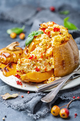Sliced pumpkin stuffed with couscous and vegetables.