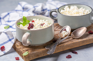 Cottage cheese with dried cranberries in a ceramic bowl.