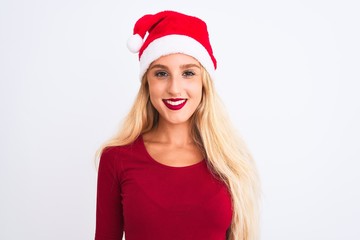 Young beautiful woman wearing Christmas Santa hat over isolated white background with a happy and cool smile on face. Lucky person.