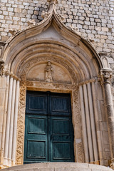 Fototapeta na wymiar Church gate in the old town and city walls of Dubrovnik, Dalmatia, Croatia, architectural detail, the most popular touristic destination