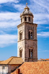 Fototapeta na wymiar Bell tower in the historic centre of Dubrovnik, Dalmatia, Croatia on blue summer day, the most popular touristic destination