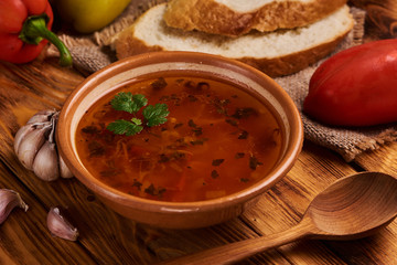 Bowl of traditional soup Borscht on wooden table. Rustic